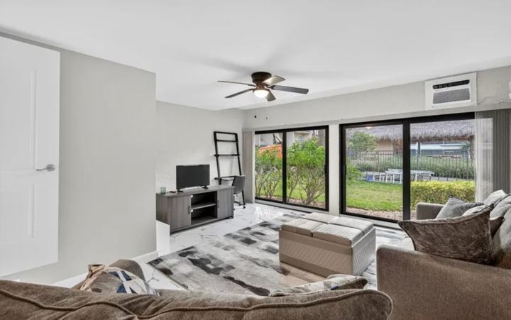 Living room with smart TV and sliding doors to the lanai in the Marco Island seasonal rental