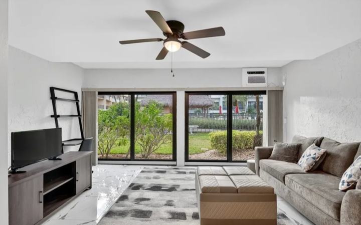 Open living area with TV console and lanai access in the Marco Island long term rental