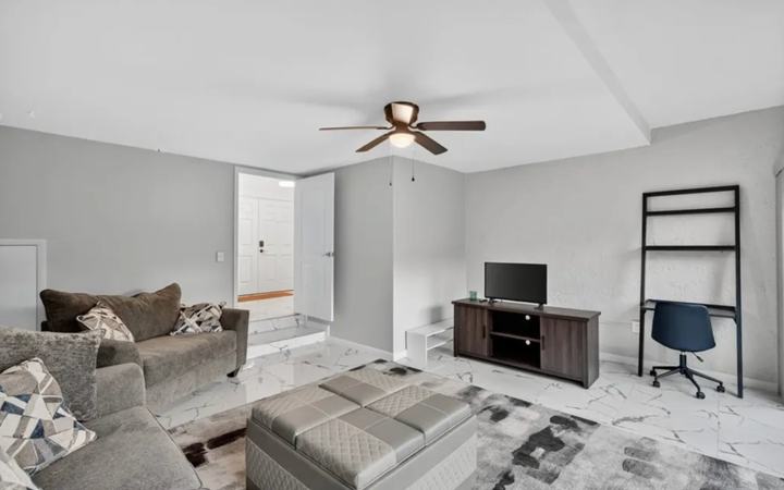 Living room with desk seating for remote work in the furnished Marco Island monthly rental