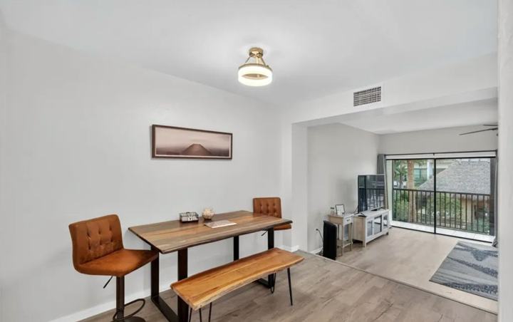 Dining area with wood table and balcony access in the Marco Island extended stay rental