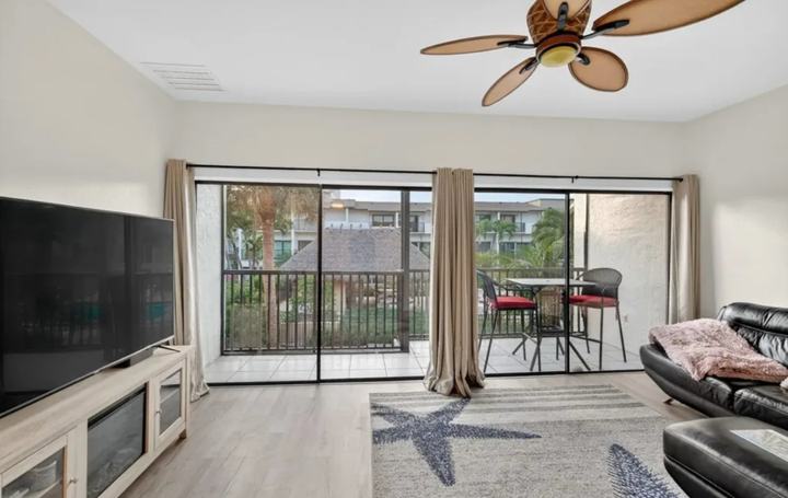 Living room with sliding doors to the screened lanai in the Marco Island snowbird rental