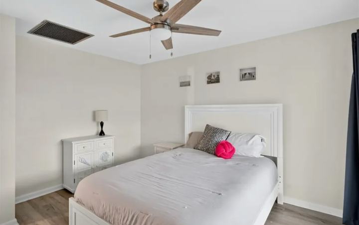 Second bedroom with dresser and ceiling fan in the Marco Island seasonal rental