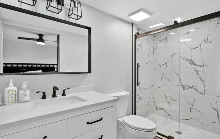 En-suite bathroom with walk-in glass shower in the Marco Island extended stay rental