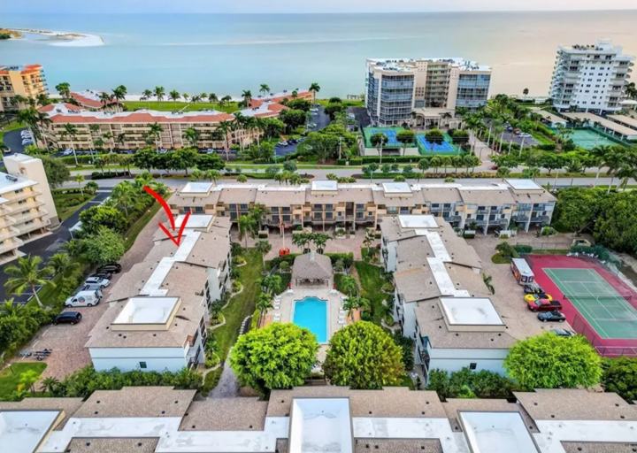 Aerial view of the Marco Island rental community with tennis court and the Gulf beyond
