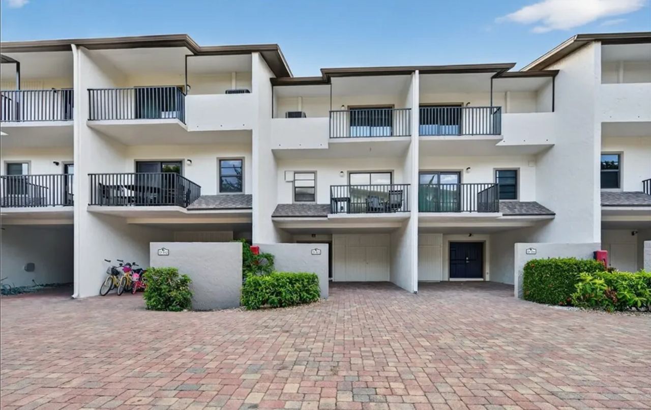 Exterior of the Marco Island long term rental townhouse with private balconies and paver courtyard