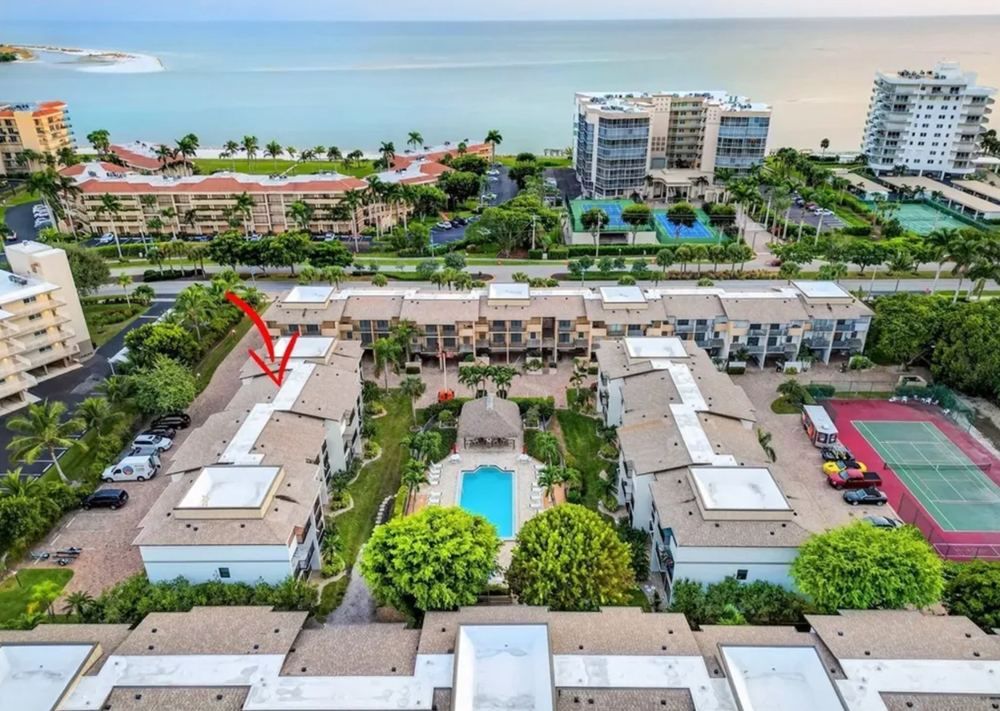 Aerial view of the Marco Island rental community with tennis court and the Gulf beyond